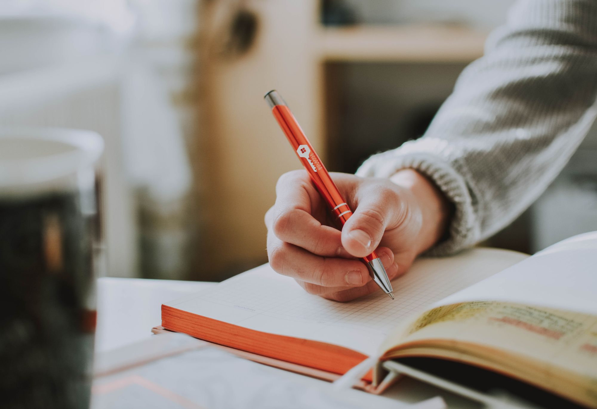 hand holding custom printed pen
